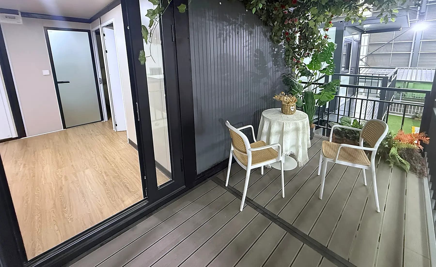 First-floor balcony with a small table and two chairs outside sliding doors