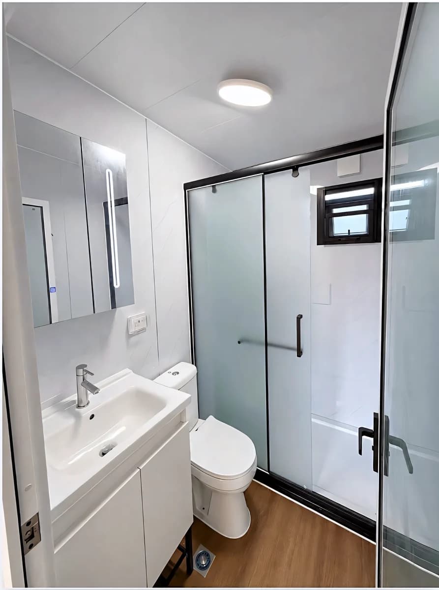 Bathroom with a wall-hung vanity and a framed glass shower