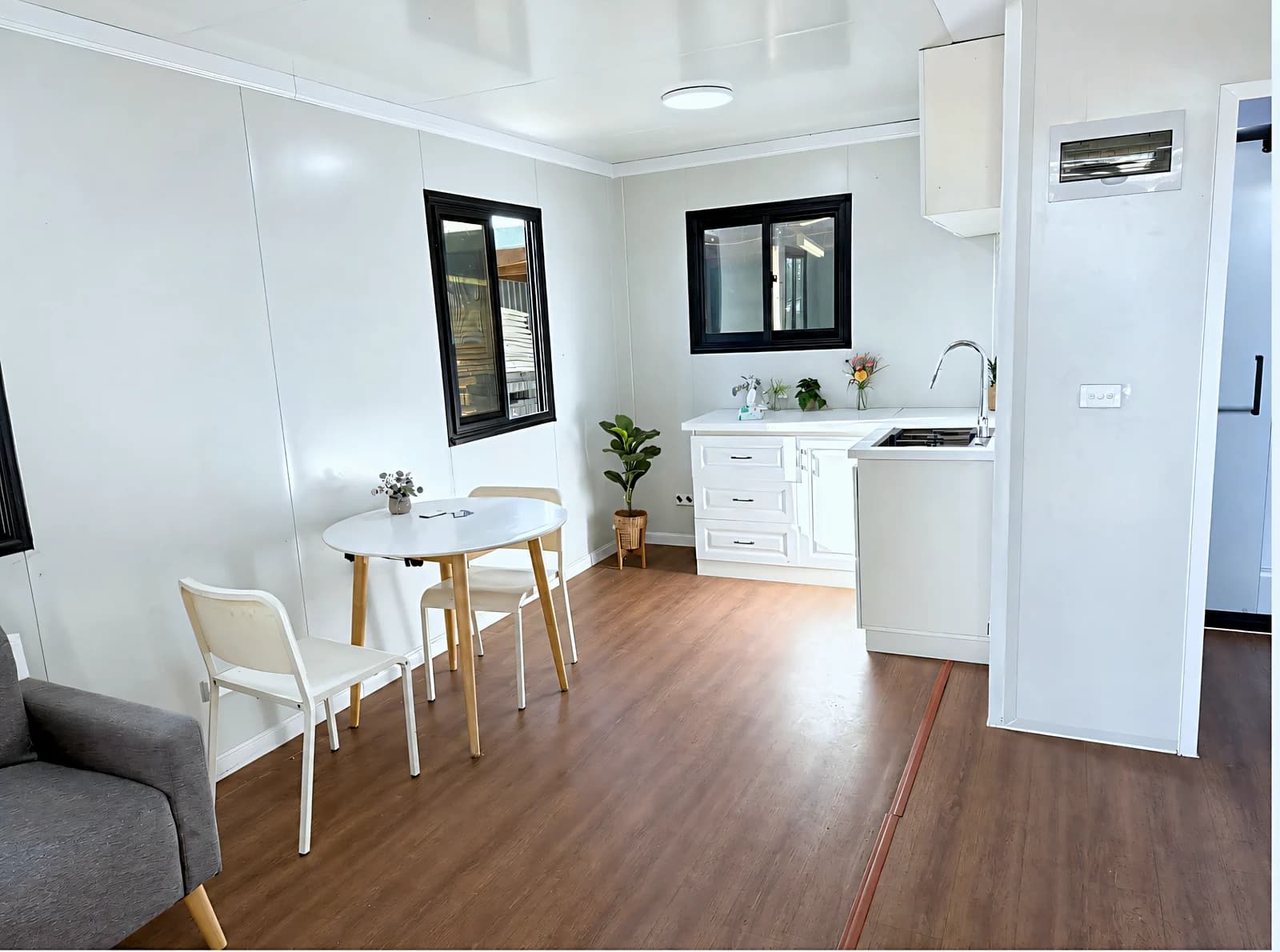 Open living and kitchen with a dining table and white cabinetry