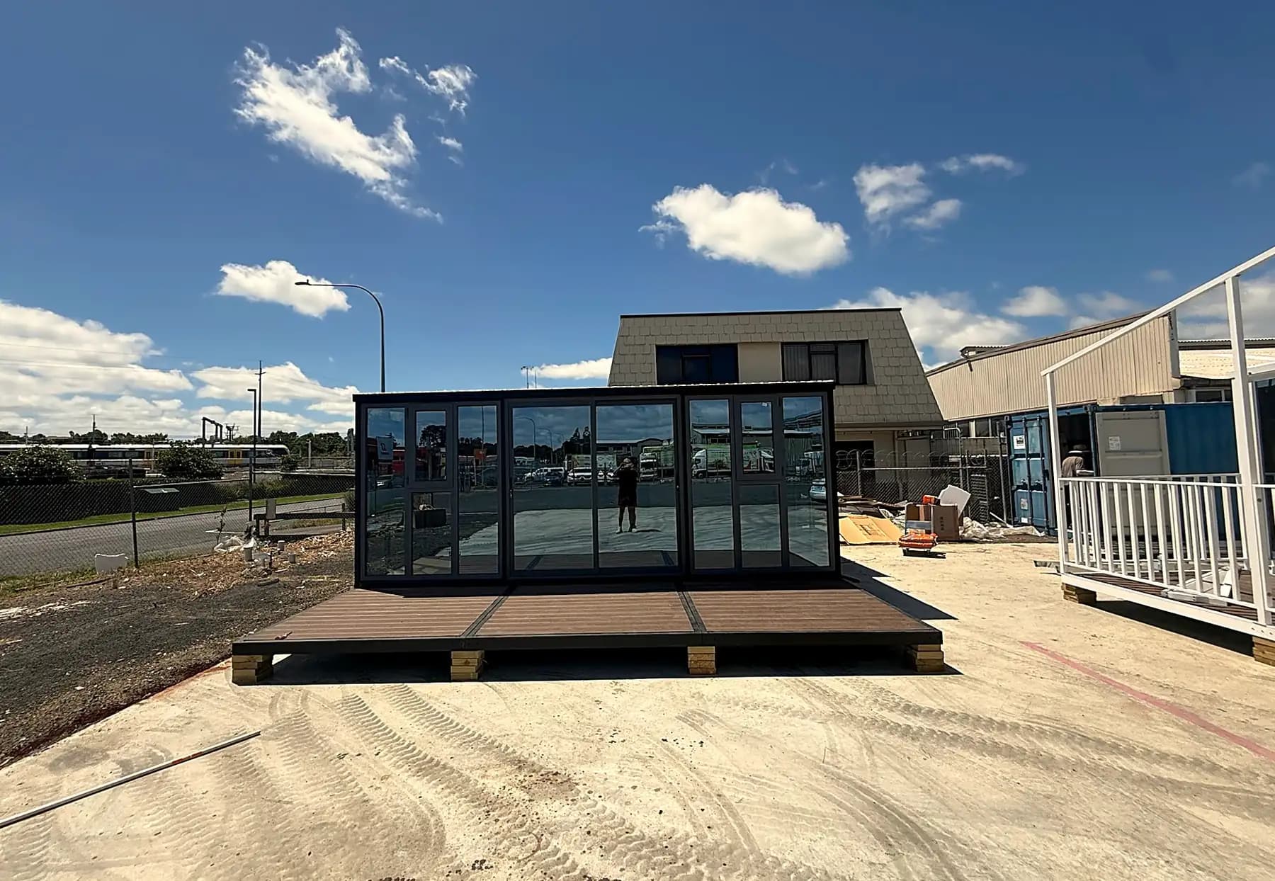 Studio unit sitting on its deck base, glazed wall facing the yard