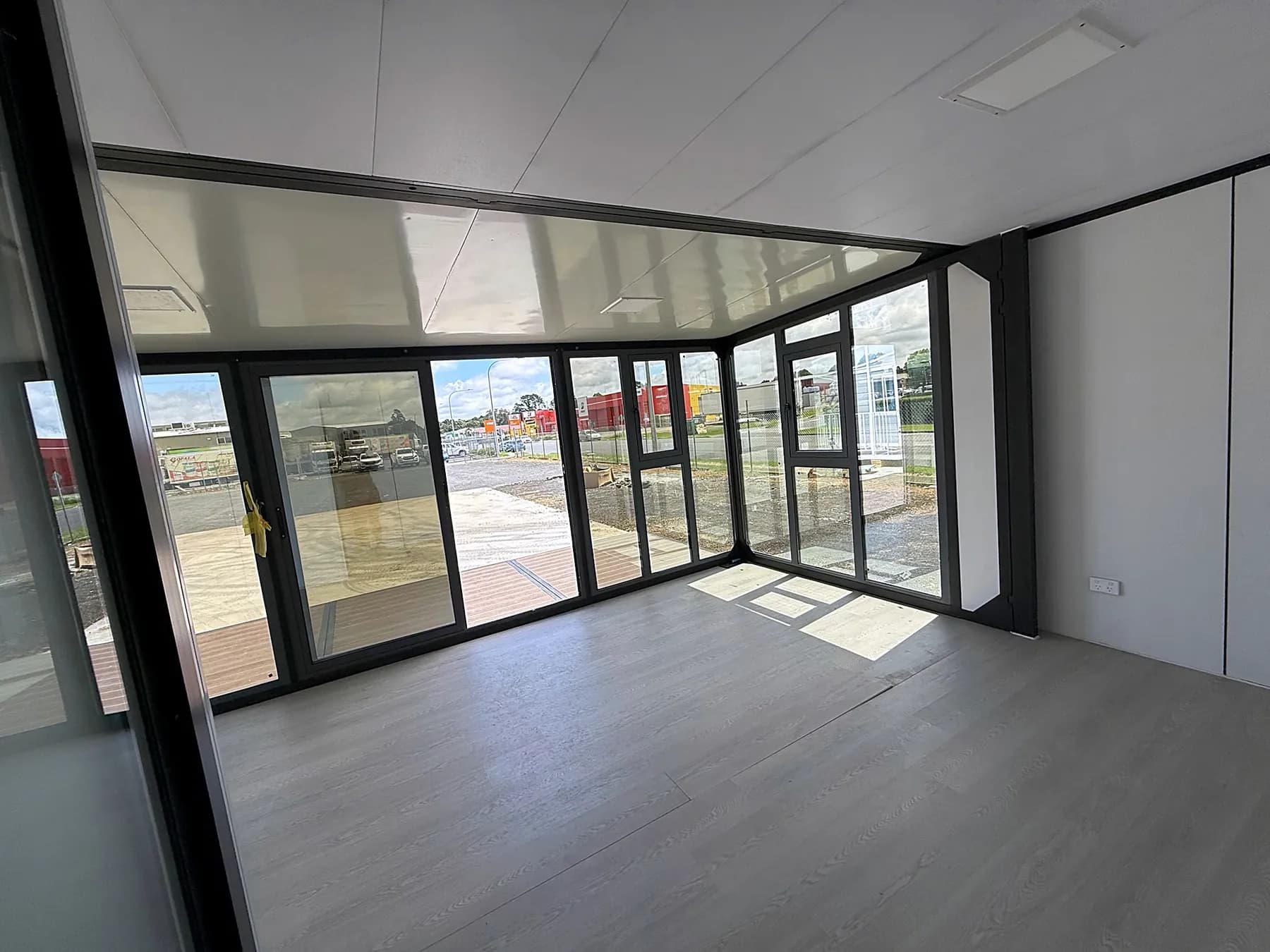 Studio Full-Wall Glass interior, glazing wrapping two sides