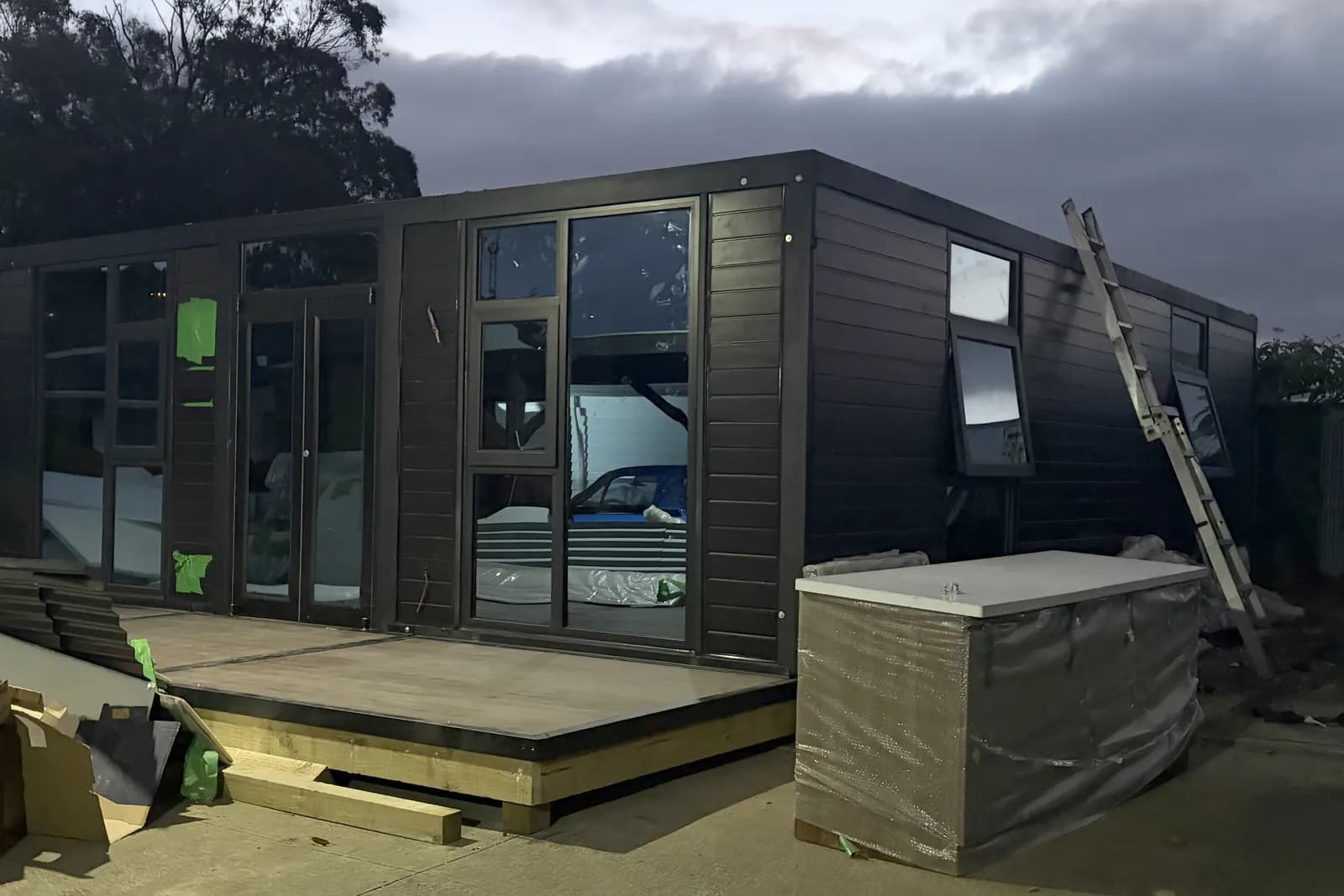 Black Comfort 30 unfolded on a customer site at dusk, with a new deck