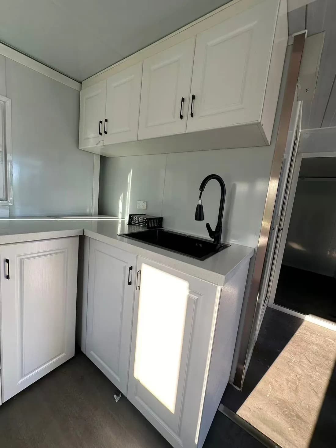 An example Ready 20 fit-out with a sink, bench and wall cabinets